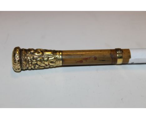 A YELLOW METAL TOPPED SWAGGER STICK