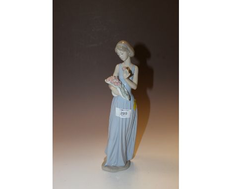 A NAO FIGURE OF A LADY HOLDING A BOUQUET OF FLOWERS