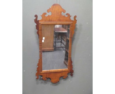 A Vauxhall type wall mirror and an ornamental giltwood cresting