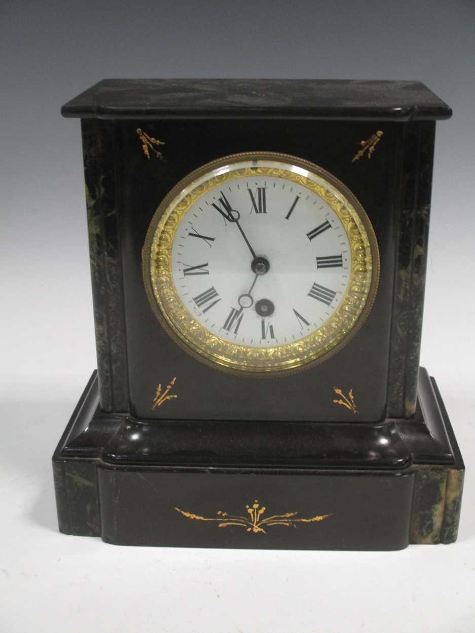 A black slate mantel clock, with Roman numerals, 23cm high in ...