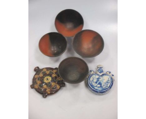 A small tinglaze heart shape flask 12.5cm high, a treacle glazed pilgrim flask, and 4 small pottery bowls (6)