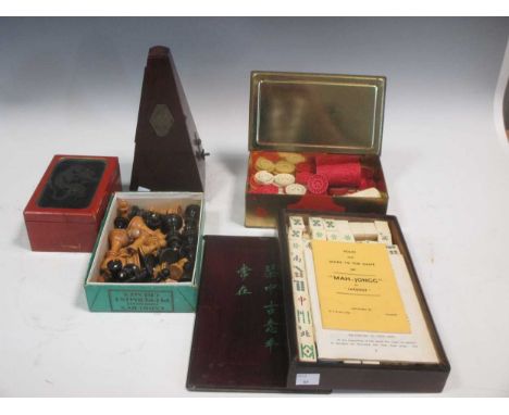 A Mah-Jongg set, stained ivory gaming counters, two chess sets and a metronome