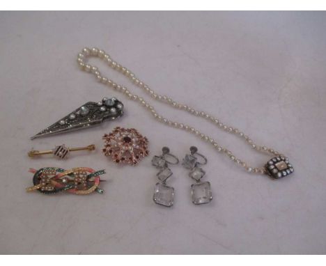 A graduated row of cultured pearls, a 9ct pearl and garnet brooch, two enamelled brooches, a pair of drop earrings and a moon