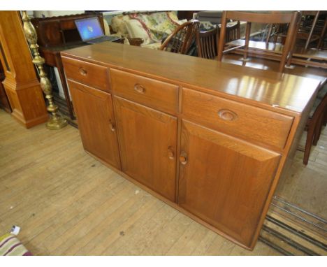 An Ercol medium elm sideboard, with three drawers and three doors 
