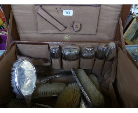 A Vintage leather travelling vanity case, retailed by Finnigans of London, Manchester and Liverpool, containing an assortment