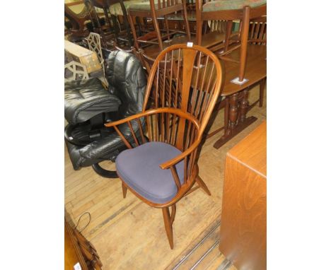 An Ercol medium elm Windsor type chair with crinoline stretcher and blue seat cushion 