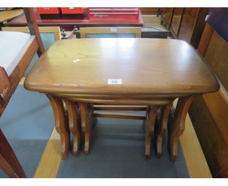 An Ercol medium elm nest of three tables 