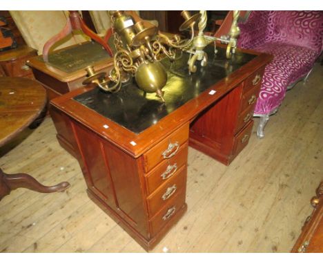 A late 19th/early 20th Century American walnut twin pedestal office desk with black inset top 