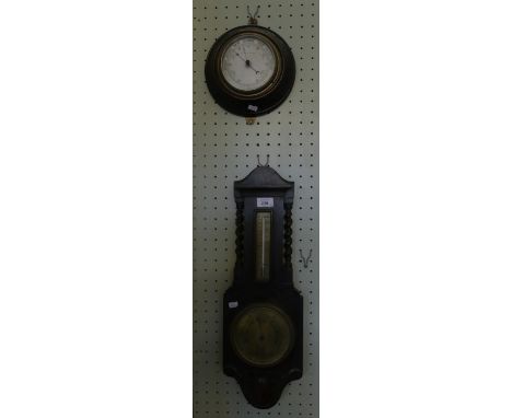 A circular aneroid barometer in carved wooden case, the face marked 'Wilson & Goodwin Ayr' together with a further oak cased 