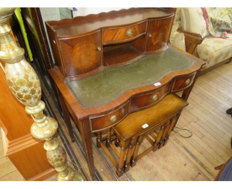 A reproduction mahogany bonheur du jour desk, fitted with two doors and four drawers, raised on tapering legs 