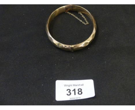 A 9ct gold hinged bangleThe faceted bangle with hinged reverse, hallmarks for Birmingham, length of inner diameter 6.3cm, wei