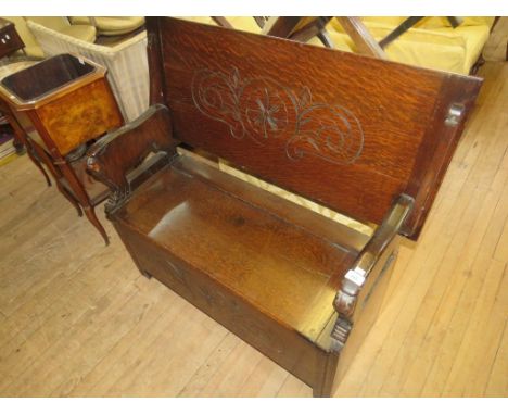 A 20th Century oak monks bench with storage base 