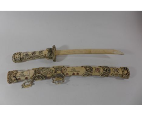 A Japanese decorative bone wakizashi, 30cm bone blade, the grip and scabbard with extensive carved decoration of flowers and 