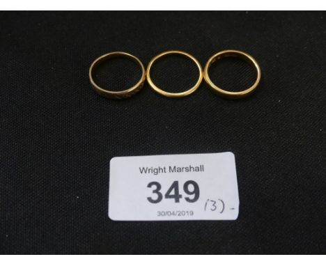 Three gold ringsTo include two 22ct gold band rings and one 18ct gold band ring, total weight approx. 8g. 