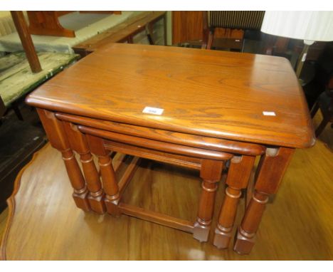 An Ercol medium elm nest of three rectangular tables 