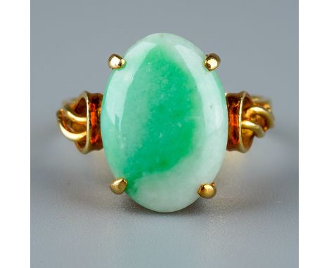 A 14k yellow gold and jade ring, set with an oval cabochon stone in four claw settings, detailed shoulders, size K1/2, total 