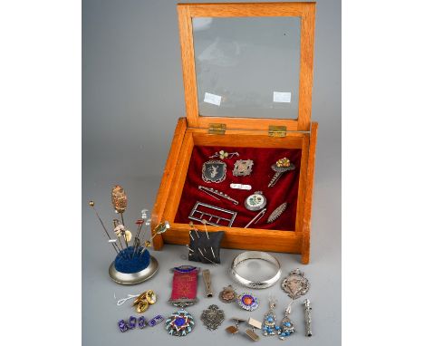 A collection of silver, including medals, enamelled badges, propelling pencil, cheroot holder, brooches, earrings, bangle, ni