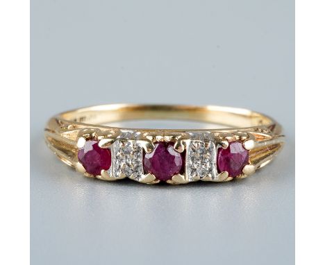 A 9ct yellow gold ruby and diamond ring, set with three round-cut rubies with diamond-chip spacers, size M1/2, total gross we