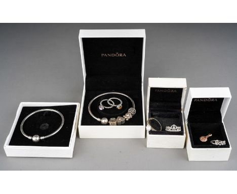 A collection of silver jewellery, including two Pandora bracelets, rings, silver and CZ rings, gold-plated charm Good conditi