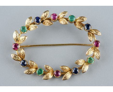 A yellow gold and gem-set oval brooch, set with rubies, emeralds and sapphires, approx 4.5cm wide, unmarked assessed as appro