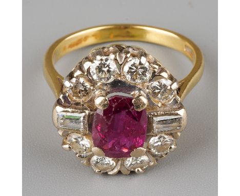 An 18ct yellow gold ruby and diamond cluster ring, set with an oval-cut ruby within a border of eight round brilliant-cut dia