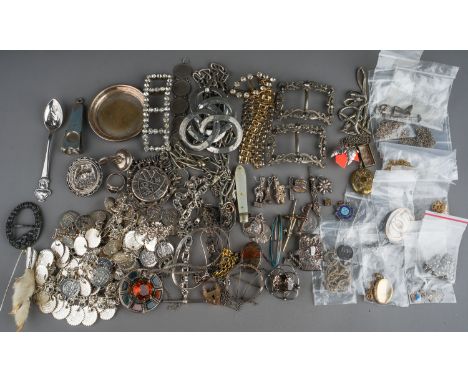 A collection of silver and white metal jewellery, including chains, watch chains, brooches, pendants, charms, Scottish hardst