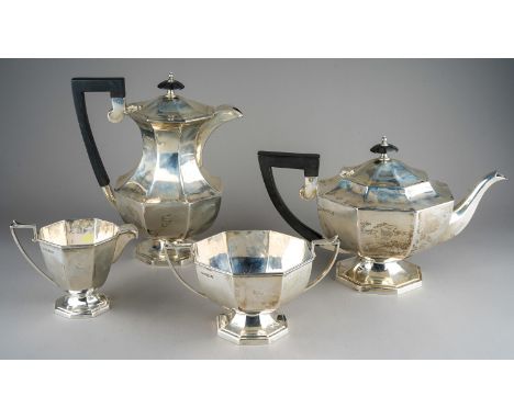 A George VI silver four piece tea service comprising teapot, milk jug, sugar bowl and hot water pot, Walker &amp; Hall silver