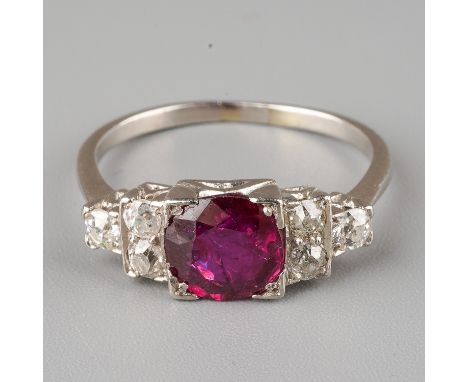 An Art Deco style ruby and diamond ring, set with a round-cut ruby flanked by six old-cut diamonds, unmarked assessed a plati