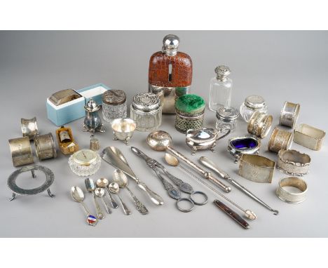 A collection of silver, including eleven silver napkin rings, silver topped dressing table jars, spoons, salt, etc; EPNS crue
