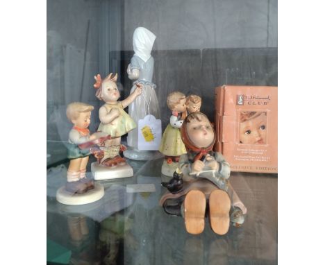 A Nao figure of girl with puppy 21cm, and four Goebel figures. 