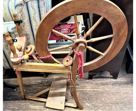 A Vintage/Antique Spinning Wheel and book. Provenance, 80 Rose Street Wokingham. 