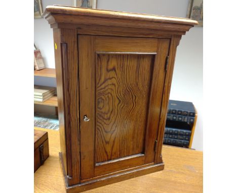 A Victorian Specimen Cabinet. The single panel door opening to reveal a series of drawers. 