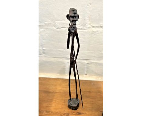 A Vintage West African Figure of an Old Man, shown holding a long stick. Circa 1950. Provenance 80 Rose Street Wokingham. 
