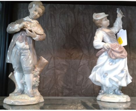 Vintage 1970's LLadro pair of figurines; boy with flowers 4757 and girl with a bird in her hand 4758 