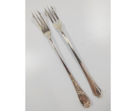 A silver Sheffield 1939 hallmarked pickle fork together with another silver-plate one. 