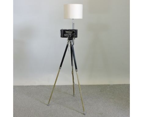 A standard lamp in the form of a camera, on a tripod, 150cm tall