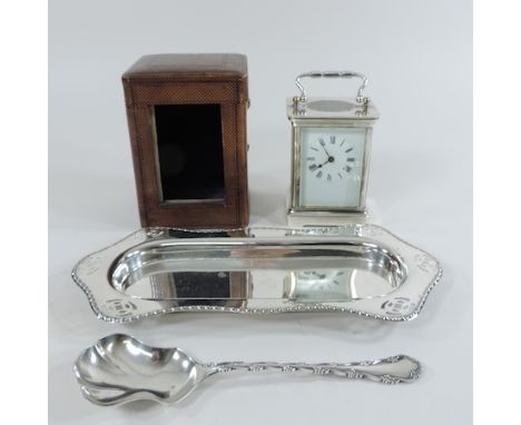 A silver plated carriage clock, 14cm tall overall, cased, together with a silver plated spoon and tray
