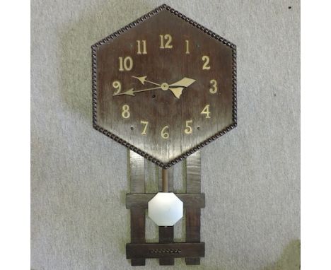 An early 20th century oak cased wall clock
