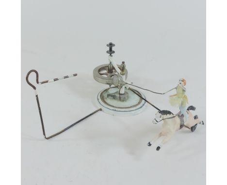 An early 20th century enamelled automaton style toy, in the form of a circus horse and rider, 9cm tall