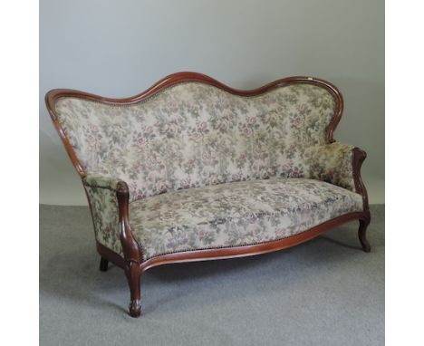 A Victorian carved walnut and tapestry upholstered show frame sofa, with floral upholstery on cabriole legs, 180cm