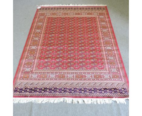 A Bokhara carpet, with all over medallions, on a red ground, 230 x 160cm