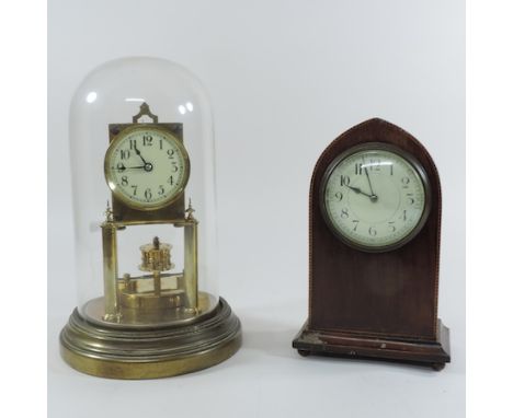 An Edwardian mahogany and inlaid lancet shaped mantel clock, 23 cm tall, together with an anniversary clock, contained under 