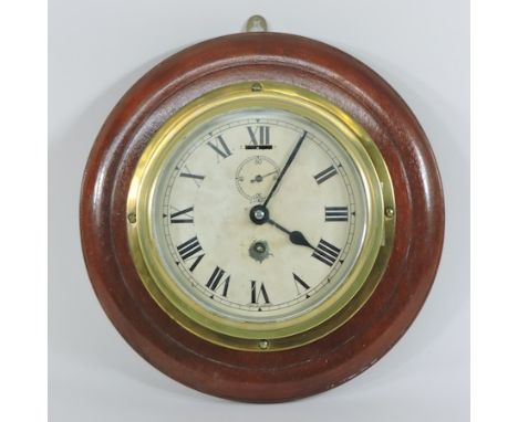 A brass ship's clock, on a mahogany mount, 28cm diameter overall