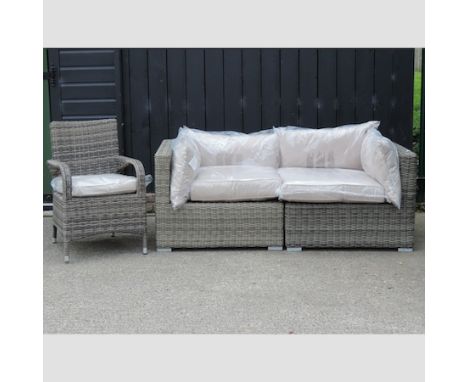 A rattan garden sofa in two sections, 177cm overall, together with a rattan garden armchair