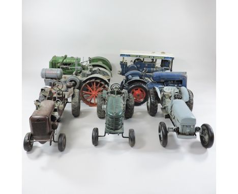 A collection of seven model tractors, largest 38cm long