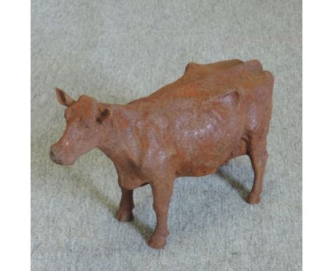 An iron garden model of a cow, 26cm tall