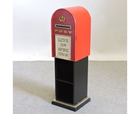 A red painted wooden shelf, in the form of a postbox