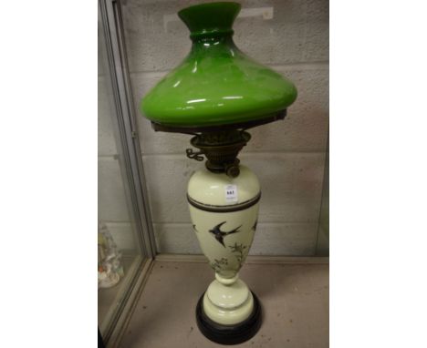 A large opaque glass oil lamp decorated with swallows (cracked to the body).