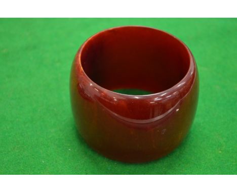 A cherry red amber style bangle.