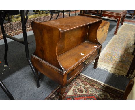 An oak double sided single drawer low book shelf.
